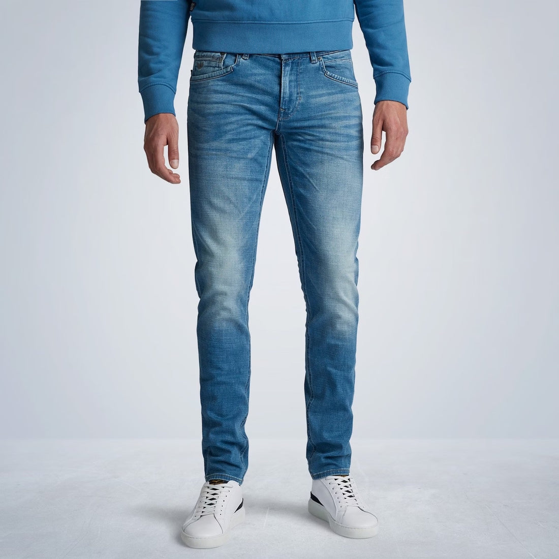 De PME Legend Tailwheel jeans is een gedetailleerde slim fit jeans met een smalle pijp. De mix van katoen en elastaan geeft de broek een zacht en comfortabel gevoel. De zachte left hand structuur zorgt voor extra draagcomfort. Deze PME legend spijkerbroek heeft een subtiele, blauwe SMB (Soft Mid Blue) wassing en mooie whiskers op de bovenbenen. Beide voorzakken worden verstevigd met een kenmerkend stuk jeans. De PME Legend borduursels op de coin pocket en de rechter achterzak maken het design af.